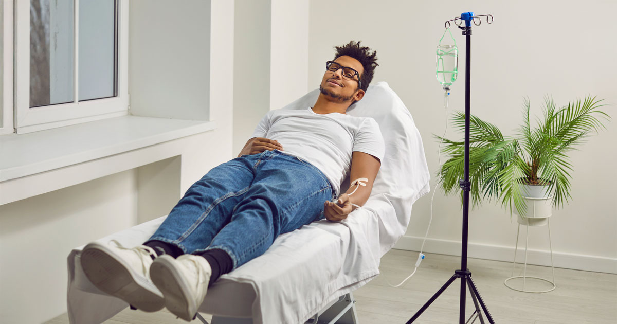 Young man receiving infusion therapy
