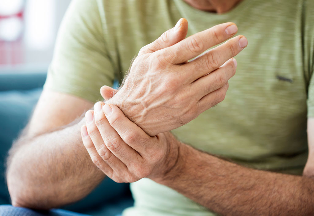 Man experiencing rheumatoid arthritis in his wrist